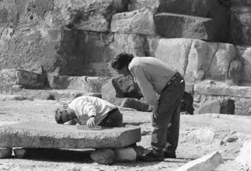 Figure 10.6 Chris Dunn and David Childress examine the granite block at Abu Roash